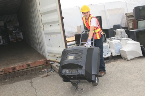 Builders loading waste into a skip on site